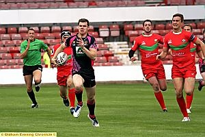 Oldham’s John Gillam makes a break against North Wales Crusaders. Oldham’s John Gillam makes a break against North Wales Crusaders.