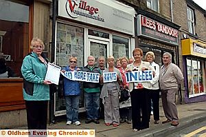Councillors Val Sedgwick and Barbara Beeley have started a petition to stop another takeaway opening in premises formerly used by a mobile phone shop — and next to an existing takeaway. Val said: “We've got too many takeaways and we don't need another one. On Friday and Saturday nights you can see the food containers all over the place.” Pictured are Councillors Sedgwick (left) and Beeley (third right) with supporters.
Councillors Val Sedgwick and Barbara Beeley have started a petition to stop another takeaway opening in premises formerly used by a mobile phone shop — and next to an existing takeaway. Val said: “We've got too many takeaways and we don't need another one. On Friday and Saturday nights you can see the food containers all over the place.” Pictured are Councillors Sedgwick (left) and Beeley (third right) with supporters.