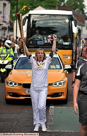 SAVOURING the moment: Moira Fields holds aloft the Olympic torch 