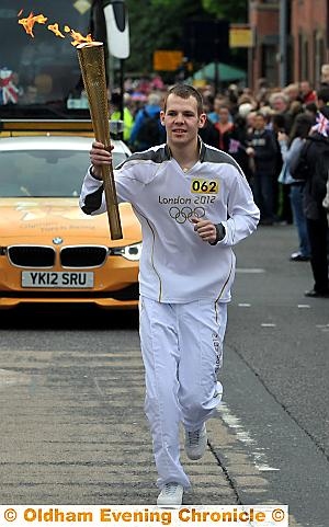 THAI boxer Andrew Lofthouse was the first Oldhamer to carry the flame in his home town. Photographs by VINCENT BROWN, DARREN ROBINSON and CHRIS SUNDERLAND 

