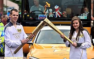 LOCAL CONNECTION... Oldhamers Andrew Lofthouse passes the flame to Megan Cordwell.