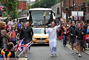 THE final leg in Oldham as Mike Lilly carries the torch down a packed Yorkshire Street to the delight of the crowds 
