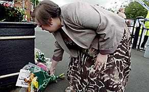 IN our thoughts . . . a well-wisher places flowers close to the scene
IN our thoughts . . . a well-wisher places flowers close to the scene