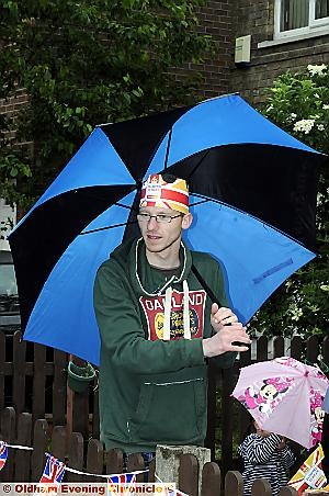 Keep warm and carry on: Corey Schofield at the street party in Leslie Street, Chadderton 
