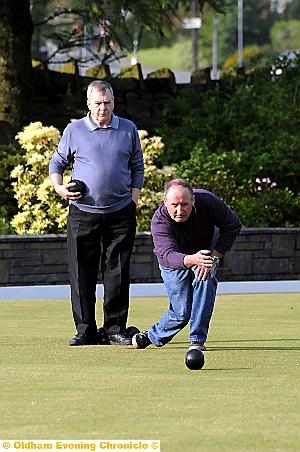 TITLE DEFENCE . . . Oldham Evening Chronicle Handicap champion Brian Raynor plays his lead bowl against Alan Whiteley. He went on to win the game, but later lost to Peter Craig. 

