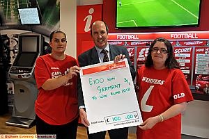 Keith McHugh receives his betting slip from Ladbrokes' Emma Moore and Janet Bradley (right).
Keith McHugh receives his betting slip from Ladbrokes' Emma Moore and Janet Bradley (right).