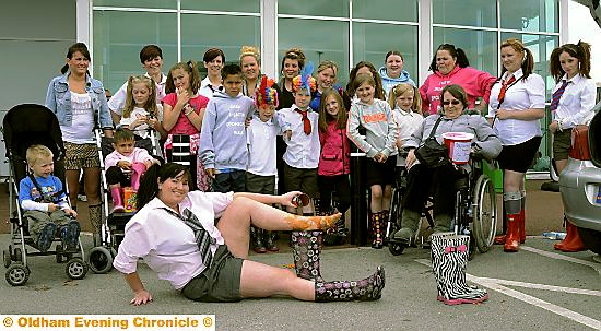 FULL of beans: Carla Cox with her family and friends as they start their sponsored walk wearing wellies full of baked beans 