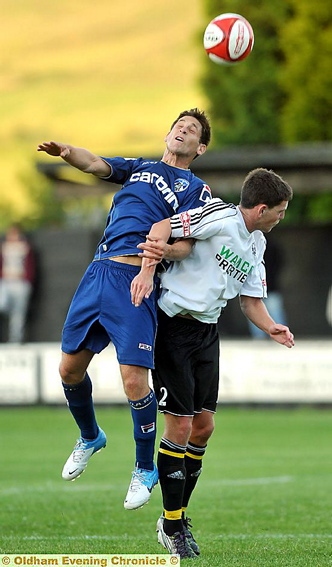 JUMP TO IT: Athletic midfielder Dean Furman climbs above his Mossley rival to win a header. JUMP TO IT: Athletic midfielder Dean Furman climbs above his Mossley rival to win a header.