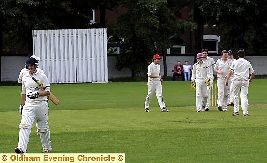 THE LONG WALK: Alan Drose of Royton trots off the field as Werneth celebrate taking his wicket. THE LONG WALK: Alan Drose of Royton trots off the field as Werneth celebrate taking his wicket.