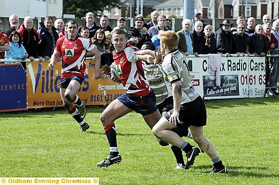 Jamie Dallimore tries to fend off a would-be Skolars tackler. Jamie Dallimore tries to fend off a would-be Skolars tackler.