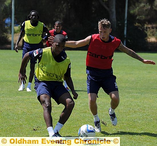 Youssouf Mchangama manages to get a pass away before Kirk Millar can get to him during training in Portugal. Youssouf Mchangama manages to get a pass away before Kirk Millar can get to him during training in Portugal.