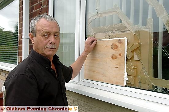 ANGRY: Andrew Tindall by the boarded-up window
ANGRY: Andrew Tindall by the boarded-up window