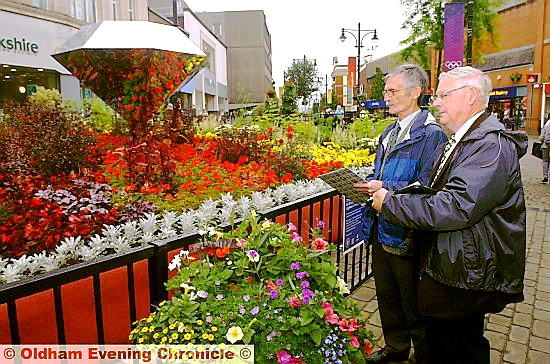 MAKING a mark . . . North-West in Bloom judges John Shepley and Brian Whalley check out Oldham’s WOW floral display in High Street
MAKING a mark . . . North-West in Bloom judges John Shepley and Brian Whalley check out Oldham’s WOW floral display in High Street