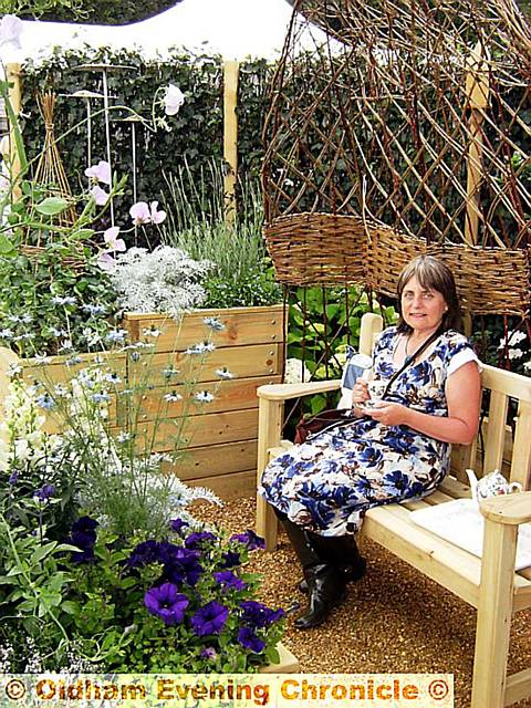 Joan Mulvenna in her award-winning care home garden at the RHS Flower Show at Tatton Park in Cheshire
Joan Mulvenna in her award-winning care home garden at the RHS Flower Show at Tatton Park in Cheshire