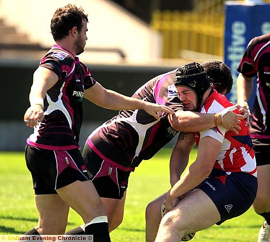 OUCH! Oldham forward Michael Ward feels the pain, while Alex Thompson (right) touches down for one of his two tries. 