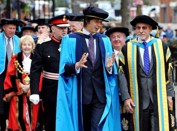 LEADING the way . . . Professor Brian Cox regales Sir Patrick Stewart as they lead the procession through Oldham town centre
LEADING the way . . . Professor Brian Cox regales Sir Patrick Stewart as they lead the procession through Oldham town centre