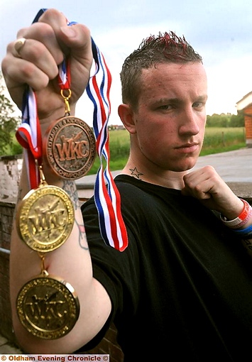 FISTFUL OF MEDALS: Mark Doyle shows off the sppils of his efforts in the Great Britain Open Karate Championships. FISTFUL OF MEDALS: Mark Doyle shows off the sppils of his efforts in the Great Britain Open Karate Championships.