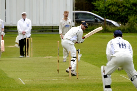 CLEANED UP . . . Heyside’s John Selby looks back in anguish as his middle stump is removed by Greenfield’s Josh Higgins. CLEANED UP . . . Heyside’s John Selby looks back in anguish as his middle stump is removed by Greenfield’s Josh Higgins.