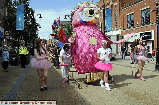 THE Owlympic procession takes to the streets. THE Owlympic procession takes to the streets.
