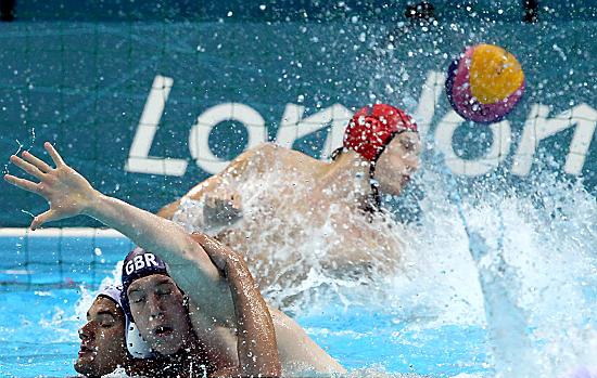 JOE O'Regan (blue cap) battles for the ball in the water polo preliminary Group ‘B’ match against Romania. JOE O'Regan (blue cap) battles for the ball in the water polo preliminary Group ‘B’ match against Romania.