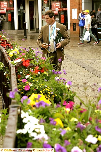 CLOSE inspection: judge Roger Burnett takes a look at the town-centre Bloom and Grow display CLOSE inspection: judge Roger Burnett takes a look at the town-centre Bloom and Grow display