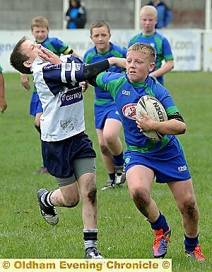 JOSH ALLEN of Waterhead hands off his Saddleworth opponent in the Year Sevens final. JOSH ALLEN of Waterhead hands off his Saddleworth opponent in the Year Sevens final.