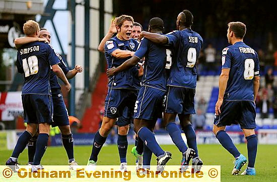 YOU’RE THE MAN . . . Athletic players rush to congratulate Jean-Yves Mvoto (third right) after he put his side 2-0 up. 