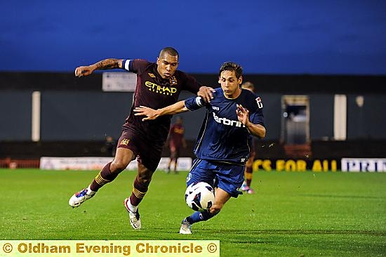 Athletic skipper Dean Furman and Manchester City counterpart Nigel de Jong go shoulder to shoulder. Athletic skipper Dean Furman and Manchester City counterpart Nigel de Jong go shoulder to shoulder.
