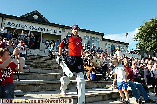 FORMER England captain Michael Vaughan accepts the applause of cricket fans as he goes out to bat in last night’s Twenty20 game between the NatWest Legends and Royton CC. 