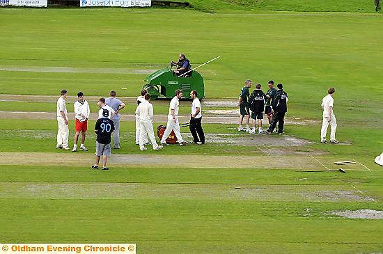SAME OLD STORY: groundstaff and players did their best to get the game on, but Royton’s CLL fixture against Walsden at th Paddock on Saturday succumbed to the weather. 