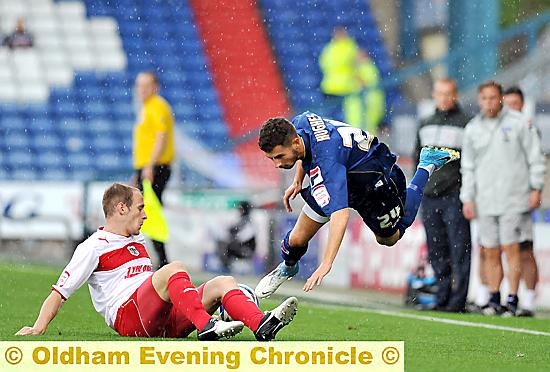 TAKING TO THE AIR: Substitute Connor Hughes is tackled during Athletic’s one-goal defeat. 