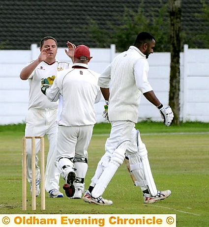 LEADING FROM THE FRONT . . Crompton skipper Carl Taylor celebrates taking the wicket of Oldham’s Atif Riaz with wicketkeeper Dave Clegg.
LEADING FROM THE FRONT . . Crompton skipper Carl Taylor celebrates taking the wicket of Oldham’s Atif Riaz with wicketkeeper Dave Clegg.