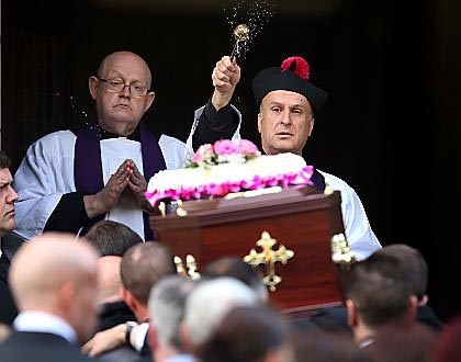CHURCH blessing the coffin is carried into the church. 