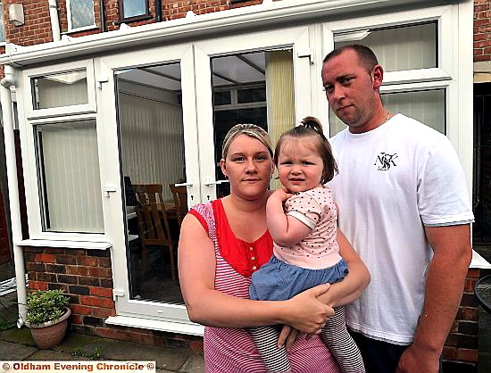 ANGER: Rachel and James Clynes with daughter Olivia and their conservatory completed by another buider after Ged Barnes left mid-way through the job  

