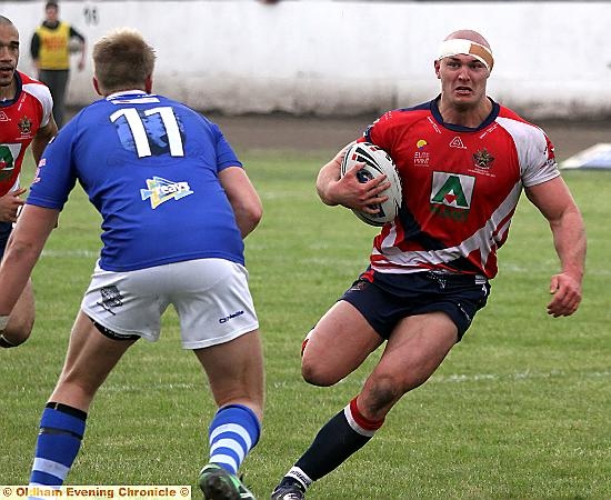 acton man: Jamie Acton, head bandaged, runs hard at the Workington defence. 