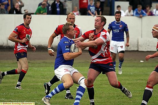Oldham’s Jason Boults attempts to halt a Workington attack. 