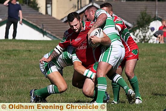 Waterhead’s Martin Sarsfield attempts to force his way through two Dewsbury Celtic tacklers. Pictures by PAUL STERRITT. 

