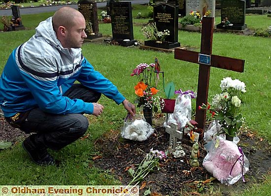 DISTRAUGHT: Paul at the grave of his daughter Violet 
