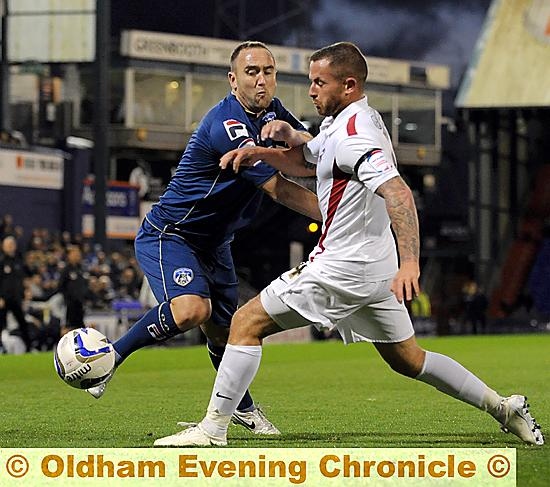 GET BACK . . . Athletic’s Lee Croft attempts to force his way down the by-line. 