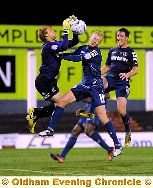 BIG TALKING POINT . . . Athletic forward Robbie Simpson and ’keeper Sam Slocombe challenge for a cross. The ball ended up in the back of the net, but the ‘goal’ was controversially disallowed. 
