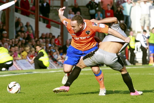 GETTING SHIRTY . . . Athletic winger Lee Croft and Brentford’s Harry Forrester are locked in a tangle. 
