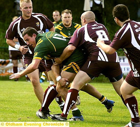 NOWHERE TO GO: Jordan Golloway of Oldham St Anne’s is stopped in his tracks by a stubborn Millom defence. NOWHERE TO GO: Jordan Golloway of Oldham St Anne’s is stopped in his tracks by a stubborn Millom defence.