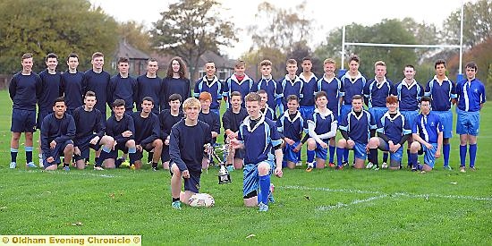 FINALISTS . . North Chadderton skipper Kieran McGinnity (front, left) and Saddleworth School counterpart Sammy Ireland parade the Year 11s trophy in front of their teams. 