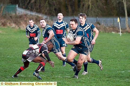 HAND OFF: James Whaley of Hollinwood about to push aside a tackle. HAND OFF: James Whaley of Hollinwood about to push aside a tackle.
