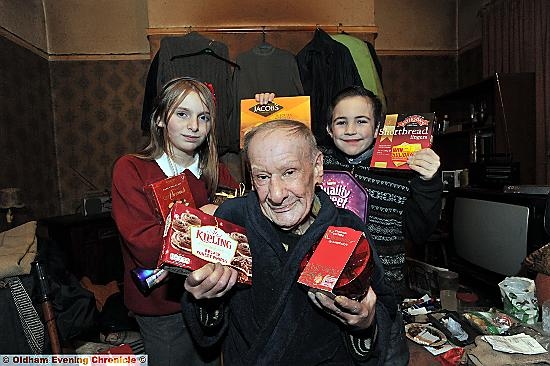 SURPRISE: Danni Maguire (left) and Caelen Malik with pensioner John Stoneley 