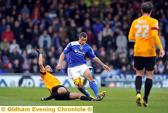 JONSON Clarke-Harris battles for the ball in front of a Boundary Park crowd which was in excess of 7,000 on Sunday. 