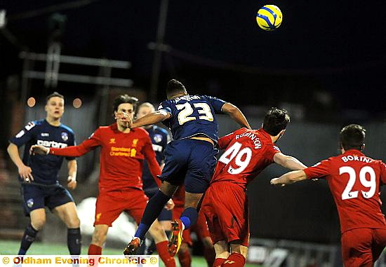 HEAD MASTER: Reece Wabara rises above a clutch of Liverpool defenders to nod home goal number three 