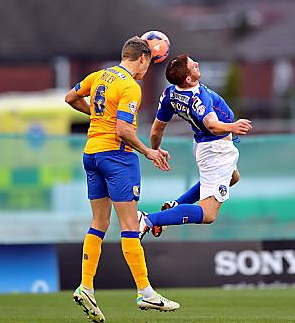 PUT YOUR BACK INTO IT: Adam Rooney displays his agility as he strives to win a header for Athletic. 