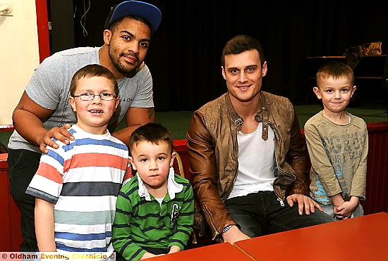 HAPPY TO SEE YOU: Oldham RL players Danny Samuel (left) and Lewis Palfrey meet young Roughyeds fans seven-year-old Callum Ogden (left), Ben Meah (five) and his brother Josh Meah (six) at Whitebank last night. 