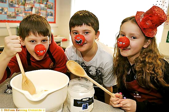 William Gilbertson, Harry Vernon and Jennifer Burgess bake cakes for sale at Firwood Manor Prep.  

